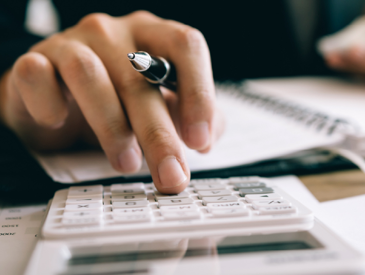 hand on a calculator entering numbers