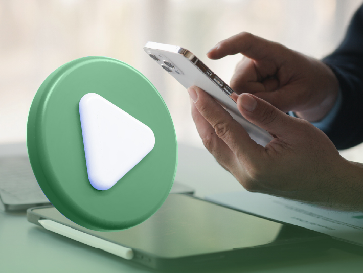 green animated video icon with hand holding a mobile phone